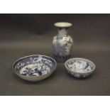 An Oriental blue and white pottery vase with lotus and bird decoration, together with a lobed edge