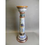 A Doulton pottery jardinière stand with raised enamel floral decoration, 27½" high (AF extensive