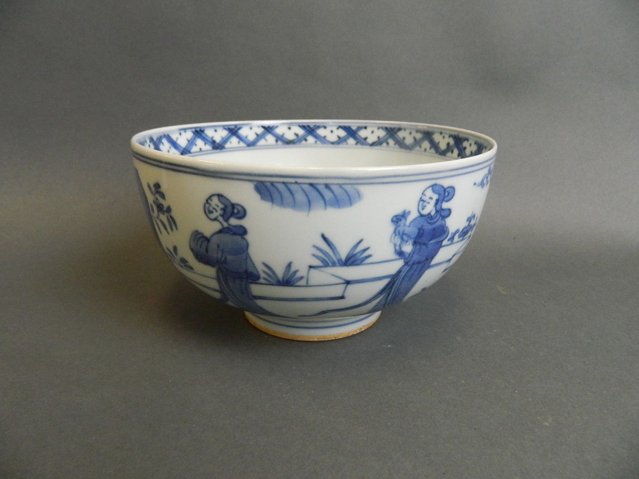 A Chinese blue and white porcelain bowl decorated with women and children in an ornamental garden, 4