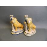 A pair of Spanish faience Majolica candlesticks in the form of lions, 9½" high