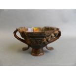 A Chinese twin handled libation cup with applied carved kylin decoration, 4" high