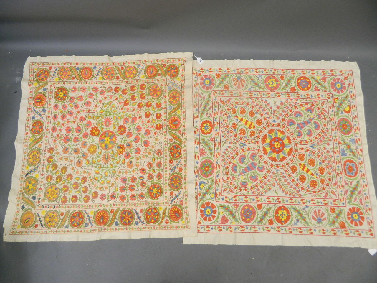 A pair of Central Asian silk embroidered Suzani Bukhara wall hangings, 40" square