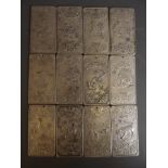 A set of twelve Chinese white metal tokens, each representing a different animal of the year, the