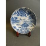 A Chinese blue and white porcelain dish with extensive riverside landscape decoration, 6 character