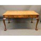 A good quality Georgian style burr walnut six drawer library table with leather inset top, raised on