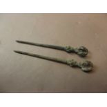 A pair of Middle Eastern bronze shroud pins, the knop with bird decoration, 4½" long