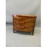 A C19th figured mahogany bow fronted chest of three graduated drawers, raised on swept supports, 43"