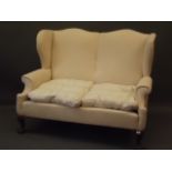 A C19th Georgian style wing back two seater settee, 59" long (AF)