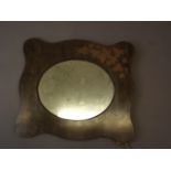 A small Art Nouveau style mirror with oval plate in a fretwork shaped frame with pokerwork ivy