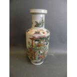 A Chinese porcelain vase with famille verte decoration depicting a fisherman offering his catch to a