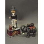 A cold painted iron money box in the form of an elephant, and another of Uncle Sam, 6" long (AF loss