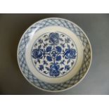 A Chinese blue and white porcelain cabinet plate with stylised peach and lotus flower decoration,