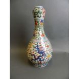 A Chinese Wucai enamelled porcelain garlic head vase with phoenix, dragon and lotus flower