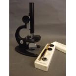 A Russian Soviet era monocular microscope with accessories, in a fitted case, 11½" high