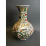 A Chinese octagonal shaped porcelain vase with dragon decoration in bright enamels, 6 character mark