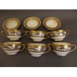 A set of 6 Limoges porcelain twin handled cups decorated in black and gilt with exotic birds