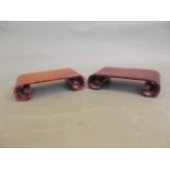 A pair of Chinese carved hardwood stands with scroll ends, 6" x 3" x 1"