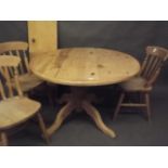 A pine draw leaf table with extra leaf, raised on a turned column and four shaped supports, together