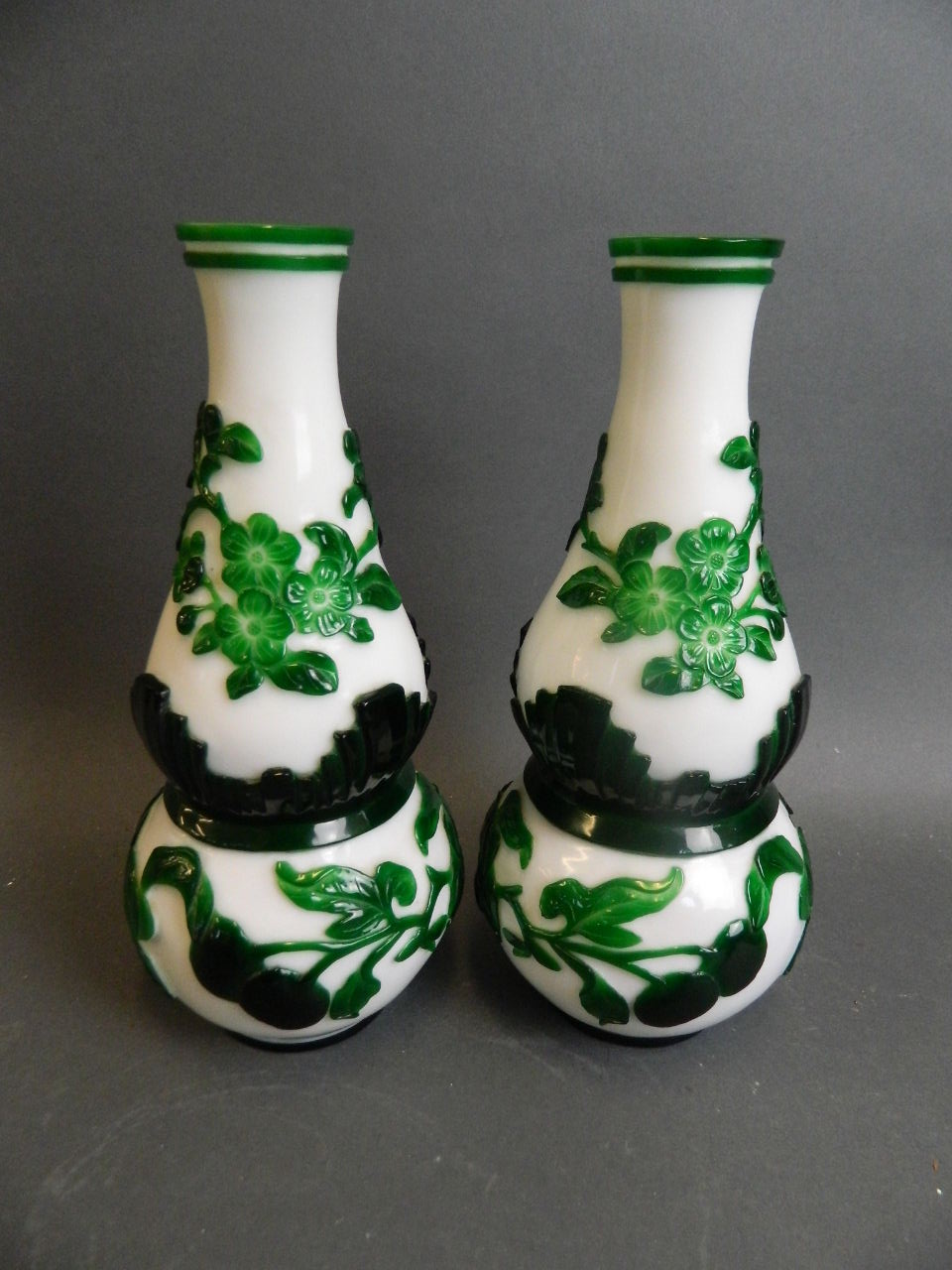A pair of Peking glass double gourd shaped vases with overlaid decoration of fruiting peach tree