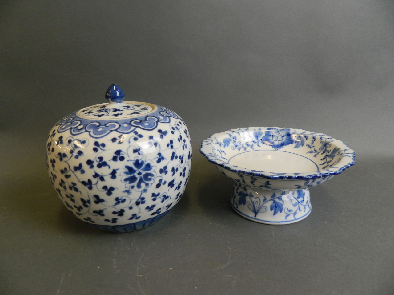 An Oriental blue and white porcelain tazza with frilled rim and floral decoration, together with a