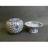 An Oriental blue and white porcelain tazza with frilled rim and floral decoration, together with a