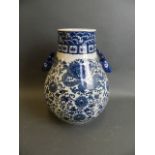 A Chinese porcelain vase with deer mask handles and blue and white dragon decoration, seal mark to