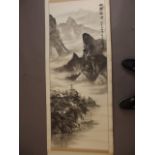 A Chinese black and white scroll depicting a mountain river landscape, signed in calligraphy with