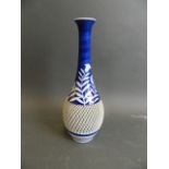 An Oriental blue and white porcelain spill vase with spiral relief design to body and floral