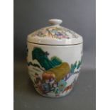 A Chinese porcelain jar and cover with raised famille verte decoration depicting a nobleman