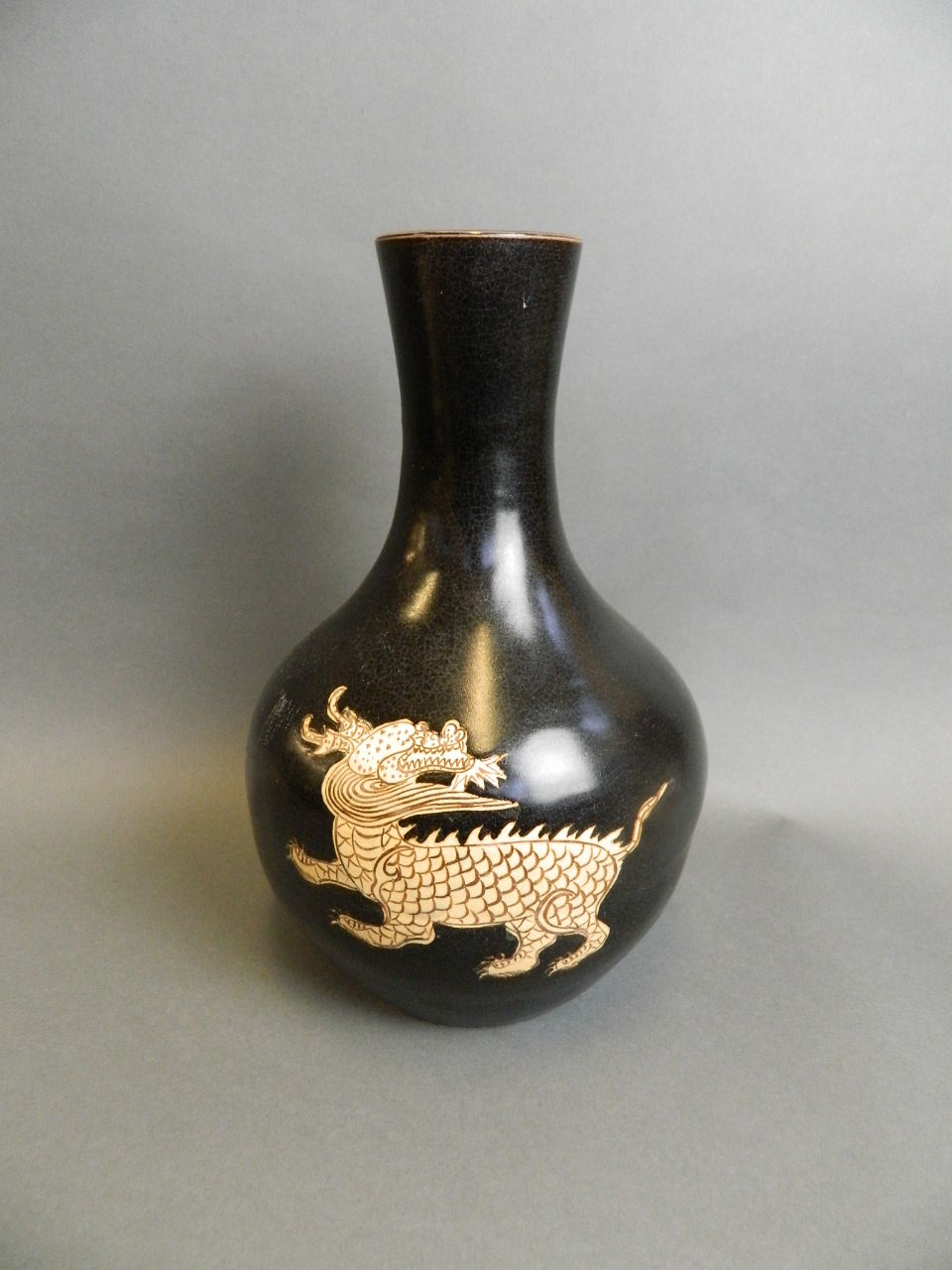 A Chinese black ground bulbous base pottery vase with incised kylin decoration, 12" high