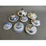 A collection of eight Chinese blue and white porcelain jar covers, largest 3½" diameter