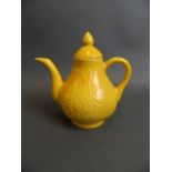 A Chinese yellow ground porcelain teapot and cover with relief decoration of birds amongst