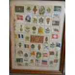 A collection of silk cigarette cards, various series sewn together and framed, 13" x 17"