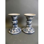 A pair of Oriental crackle glazed porcelain candlesticks with blue and white decoration of birds,