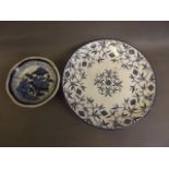 An Oriental blue and white charger decorated with symbols and stylised flowers, together with an