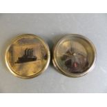 A brass pocket compass with engraved plaque of the Titanic, 2" diameter