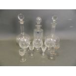 An early blown glass mallet decanter, another similar, a Webbs crystal decanter and three