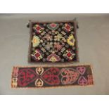 An Uzbek black ground wall hanging with silk embroidered decoration, together with another