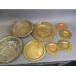 A quantity of Eastern brass and copper trays and bowls, longest 11½"