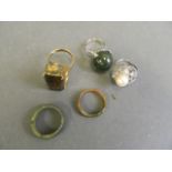 Two jade rings, a white metal set jade ball ring, and two costume dress rings