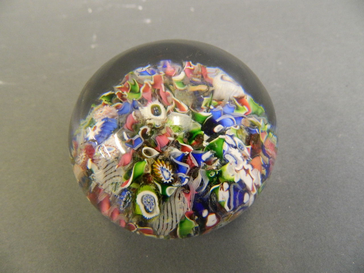 A fine Millefiori glass paperweight with multiple rods and leaves, possibly Baccarat, 2½" diameter
