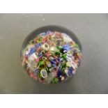 A fine Millefiori glass paperweight with multiple rods and leaves, possibly Baccarat, 2½" diameter