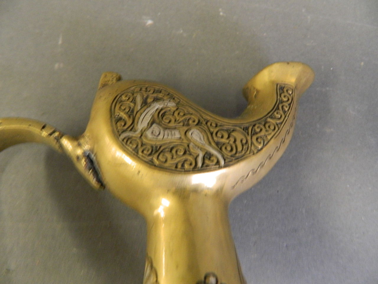 An Islamic polished bronze pourer with silver inlaid decoration, 8½" high (lacks lid) - Image 3 of 3