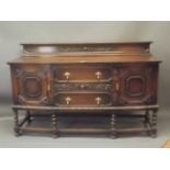 A large Victorian shaped front sideboard with end cupboards flanking two drawers and spring loaded