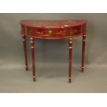 A Chinese red lacquer single drawer demi line side table with gilt chinoiserie decoration, raised on