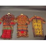 Three Afghan women's silk dresses with decorative embroidery and inset mirror glass decoration,