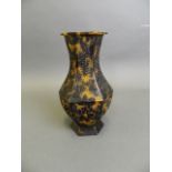 A Chinese carved and pierced faux tortoiseshell hexagonal vase decorated with a stork in flight,