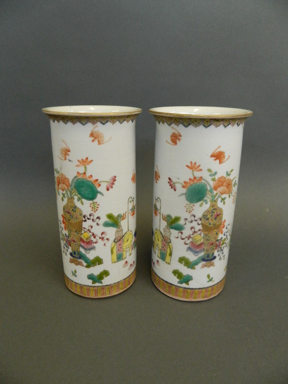 A pair of Chinese porcelain cylinder vases with enamel decoration of objects of virtue, seal mark to
