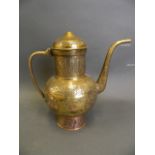 An Islamic polished brass water pot with silver and copper inlaid decoration, 10½" high
