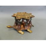 An Eastern lacquered bronze oil burner in the form of an eight pointed star raised on a tortoise's